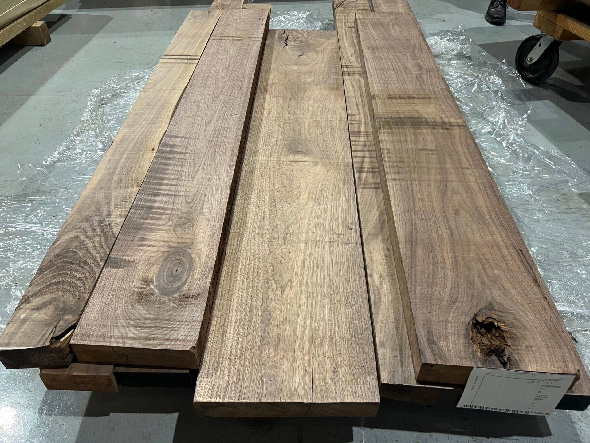 A pile of wood sitting on top of a concrete floor.