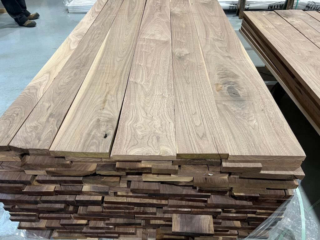 A stack of wooden boards sitting on top of each other on a table.