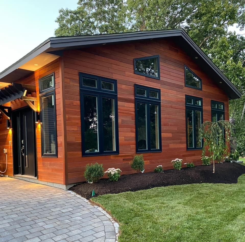 A small wooden house with a lot of windows