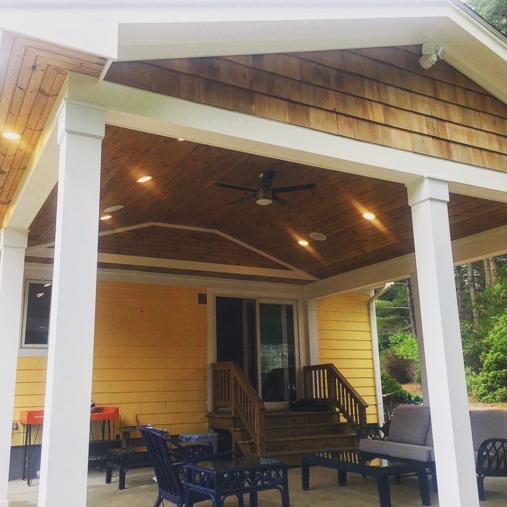 A porch with furniture and a ceiling fan