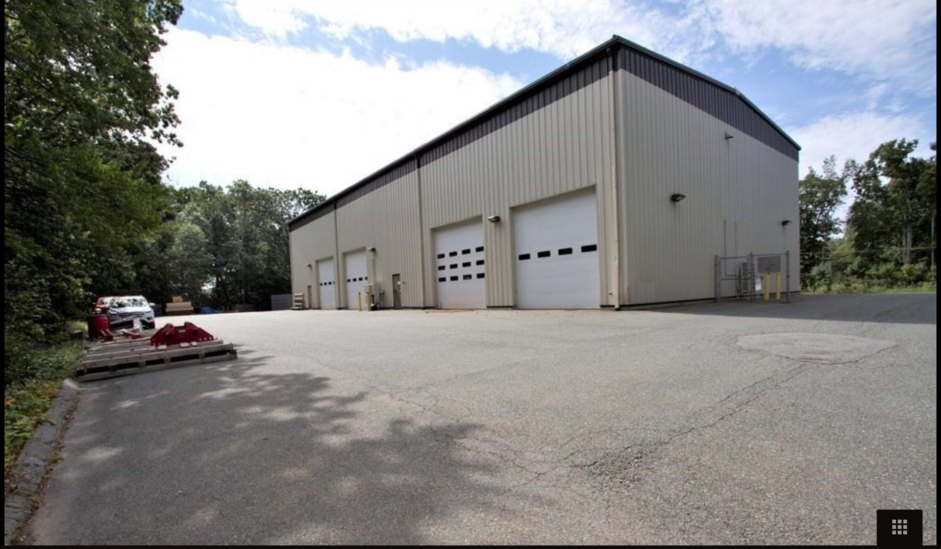 A large building with a lot of white garage doors