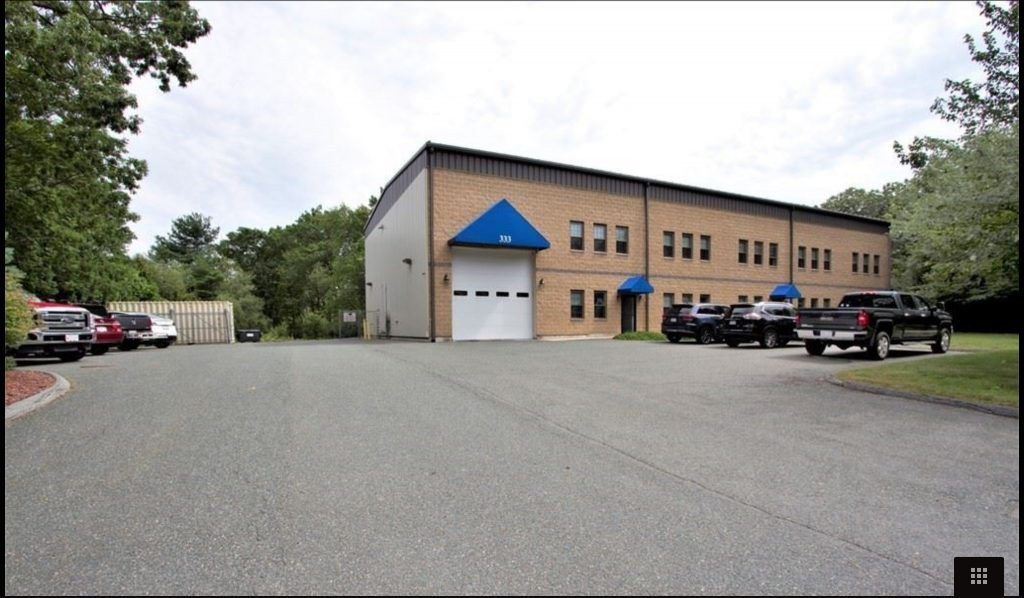 A building with a blue roof and a white garage door