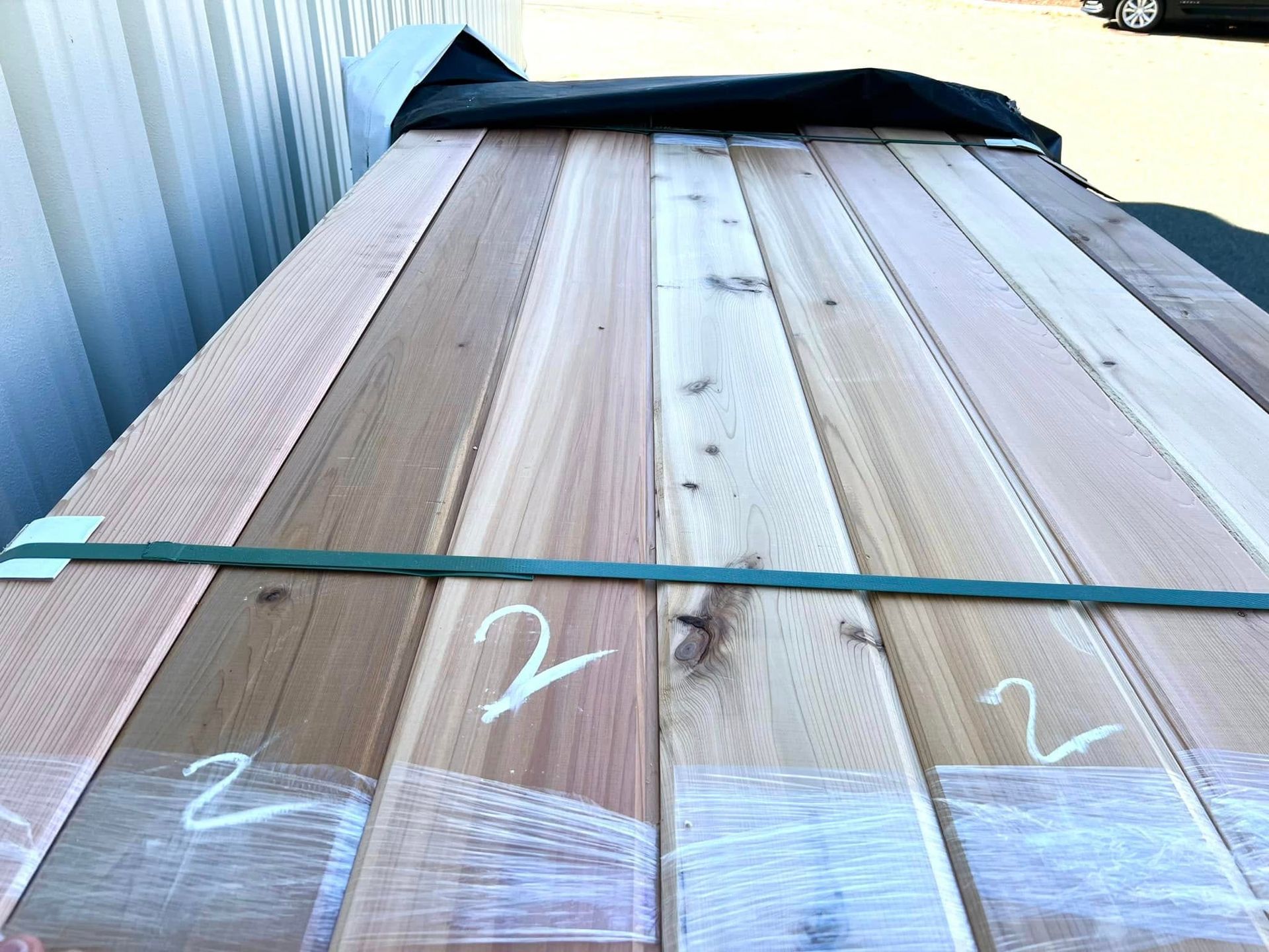 A stack of wooden boards with the numbers 2 and 2 written on them.