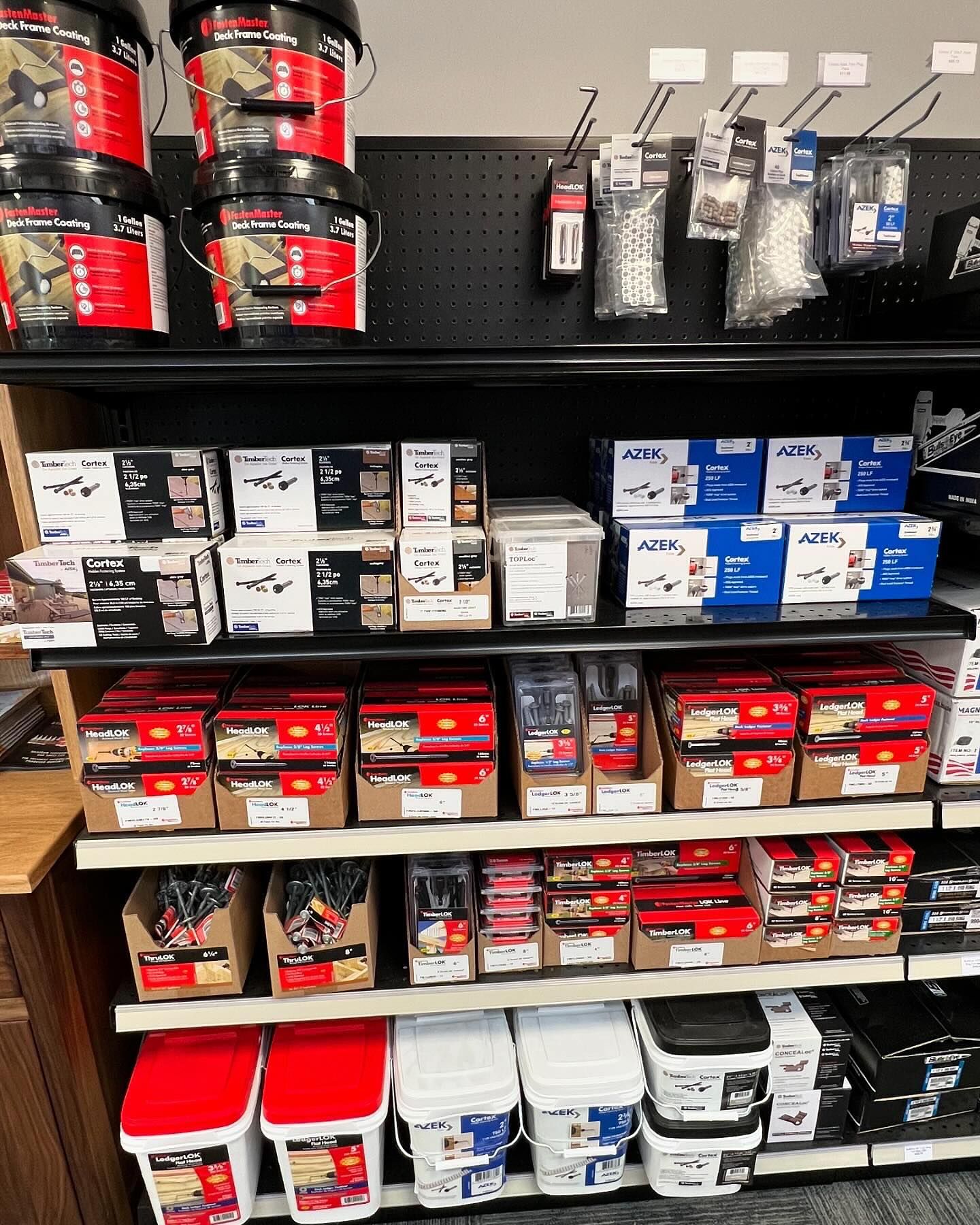 A store shelf filled with lots of boxes and buckets.
