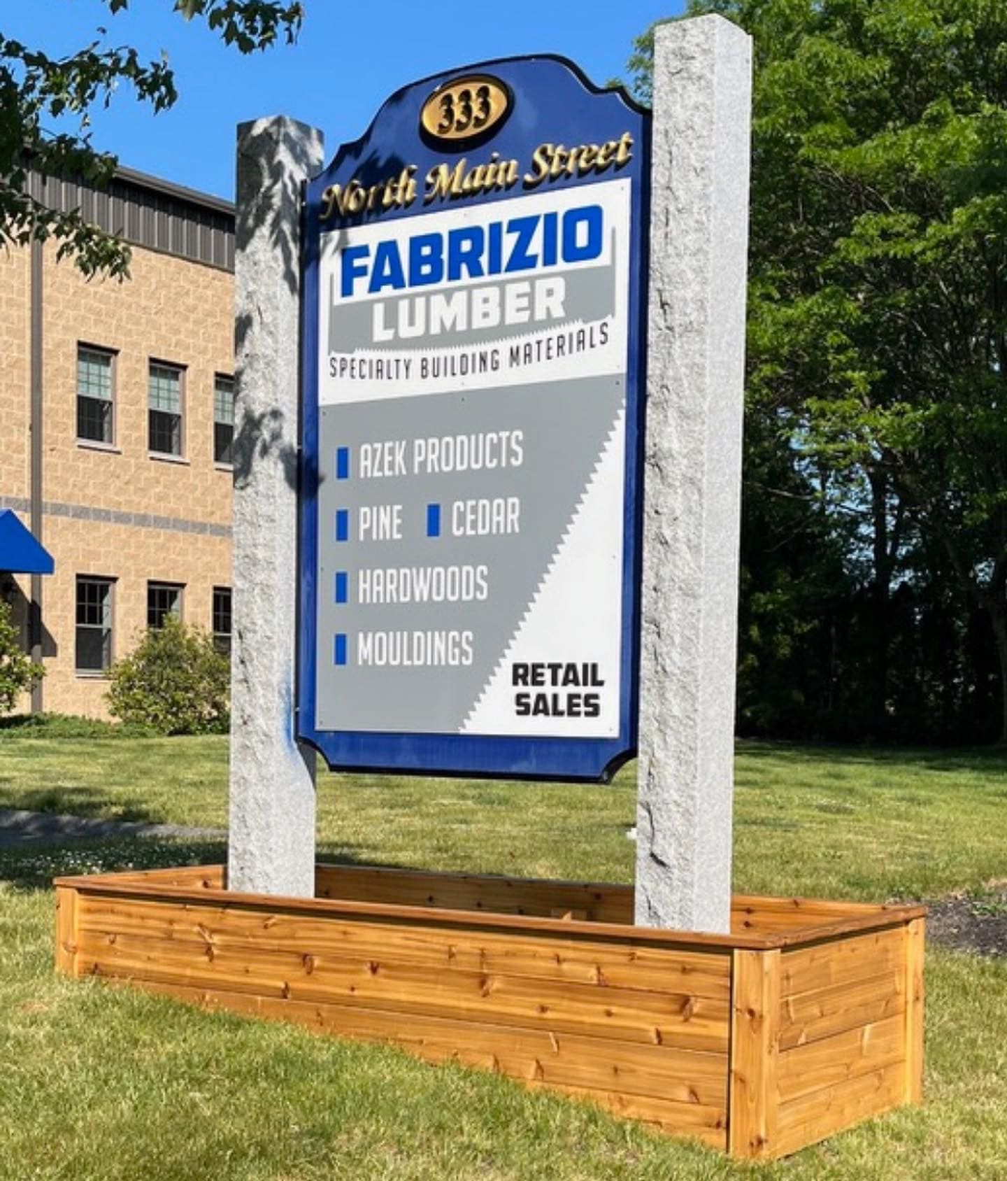 A sign for fabrizio lumber is in front of a building