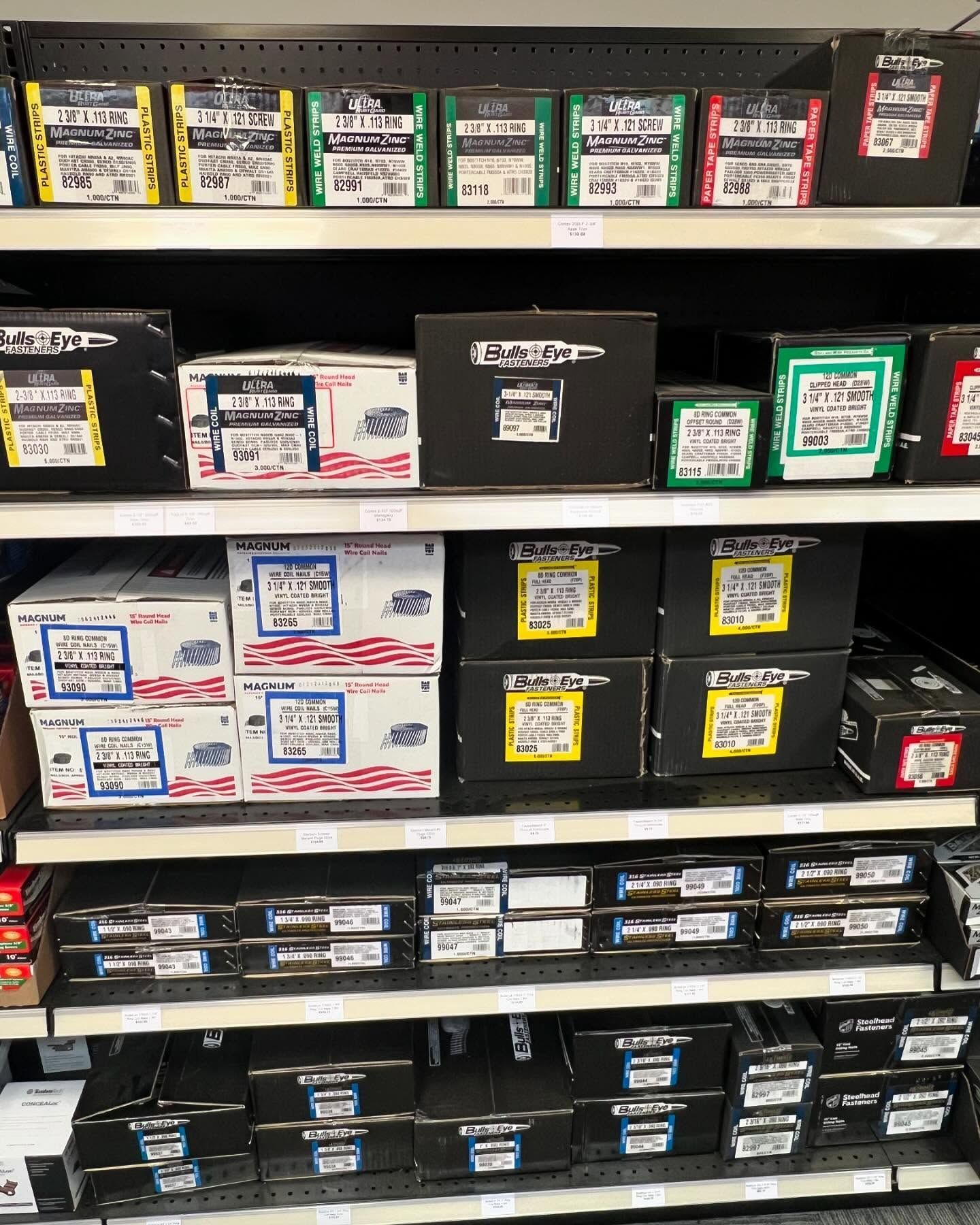 A shelf filled with boxes of nuts and bolts