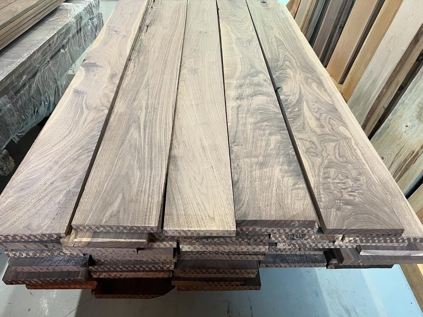 A stack of wooden boards sitting on top of each other on a table.