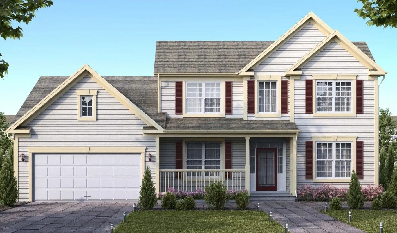 Two-story beige house with a white garage, front porch, and manicured lawn under a clear sky
