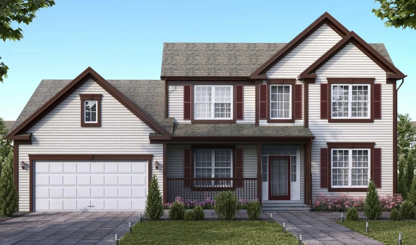Suburban two-story house with gray siding, brown trim, front porch, attached garage, and manicured lawn