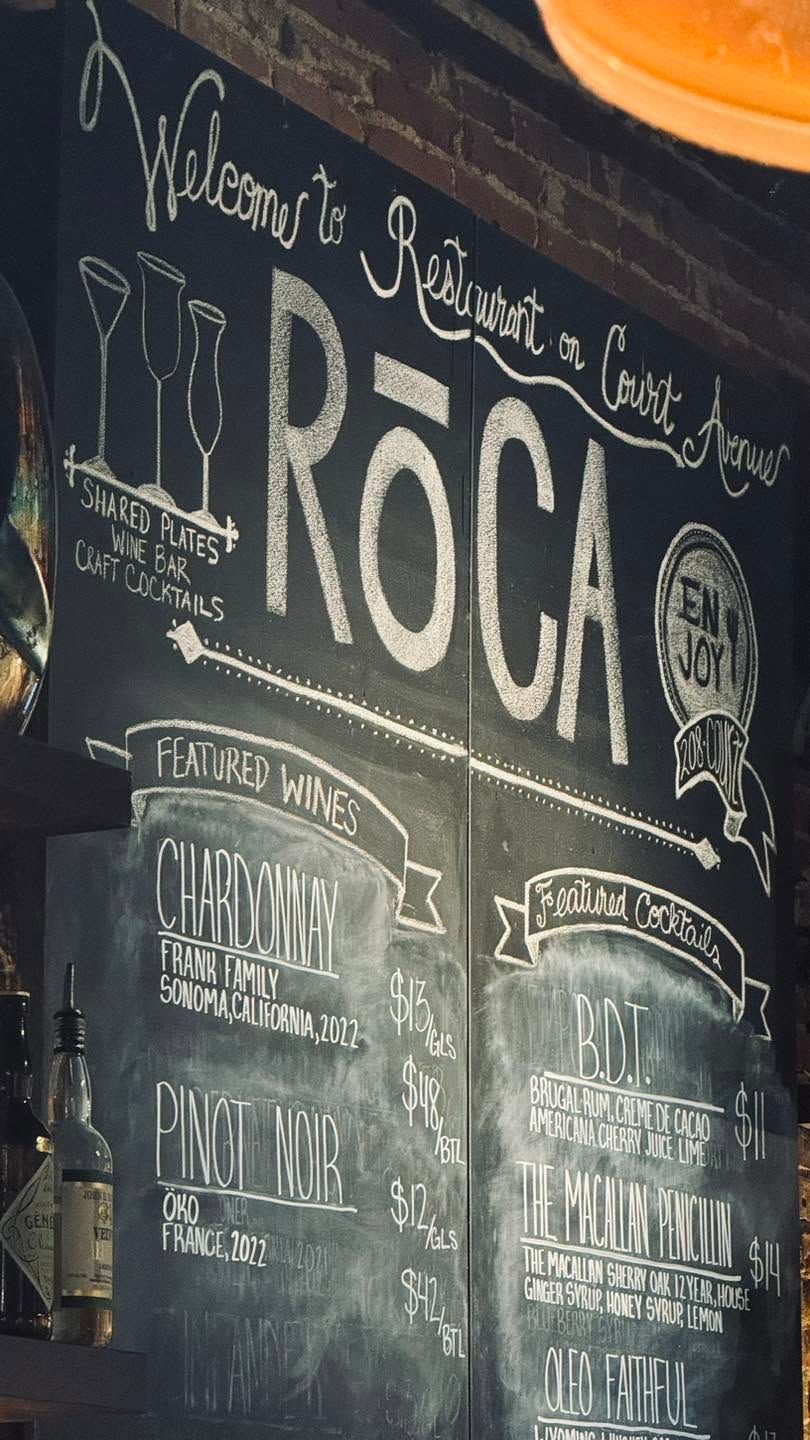 Chalkboard restaurant wall menu with large “ROCA” lettering and cocktail drawings