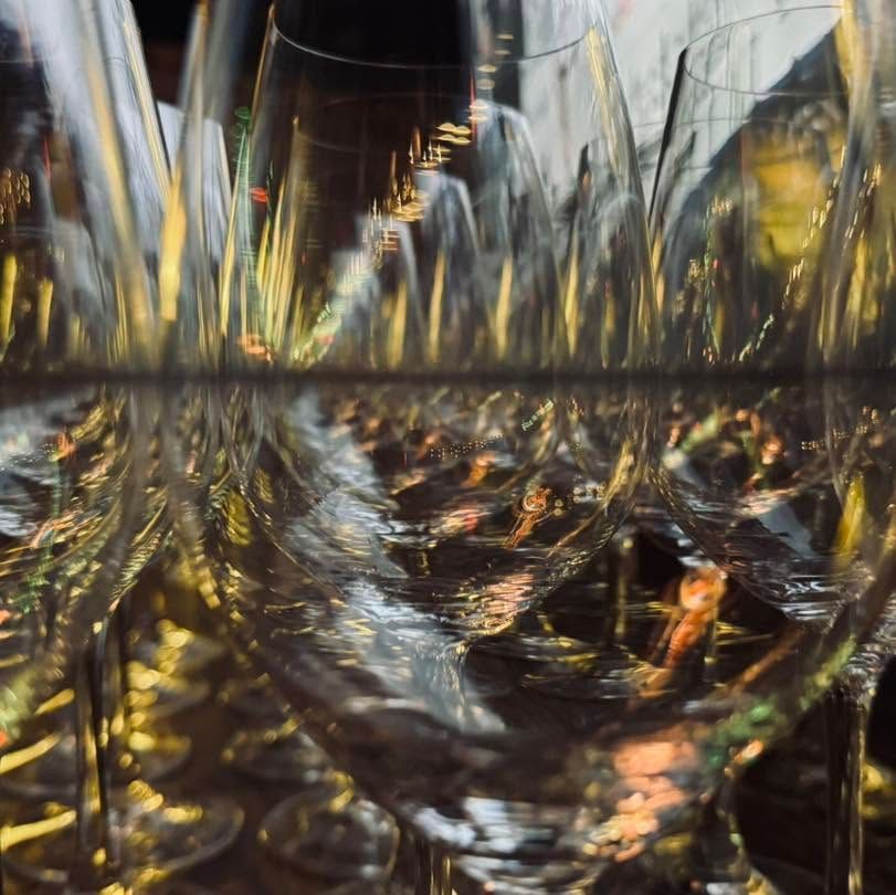 Abstract close-up of shimmering glass with golden reflections and distorted light patterns