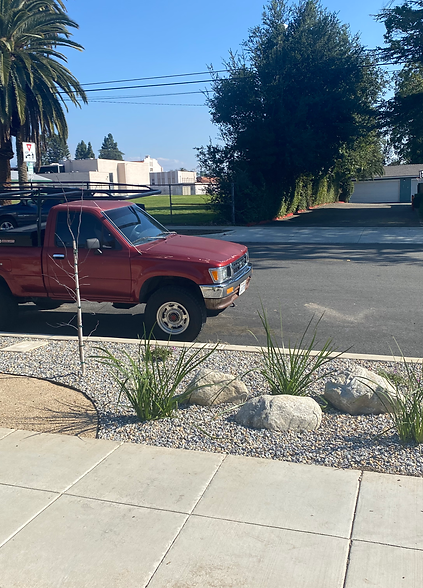 A red truck is parked on the side of the road