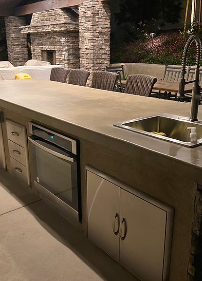 A kitchen with a sink , oven , and microwave.