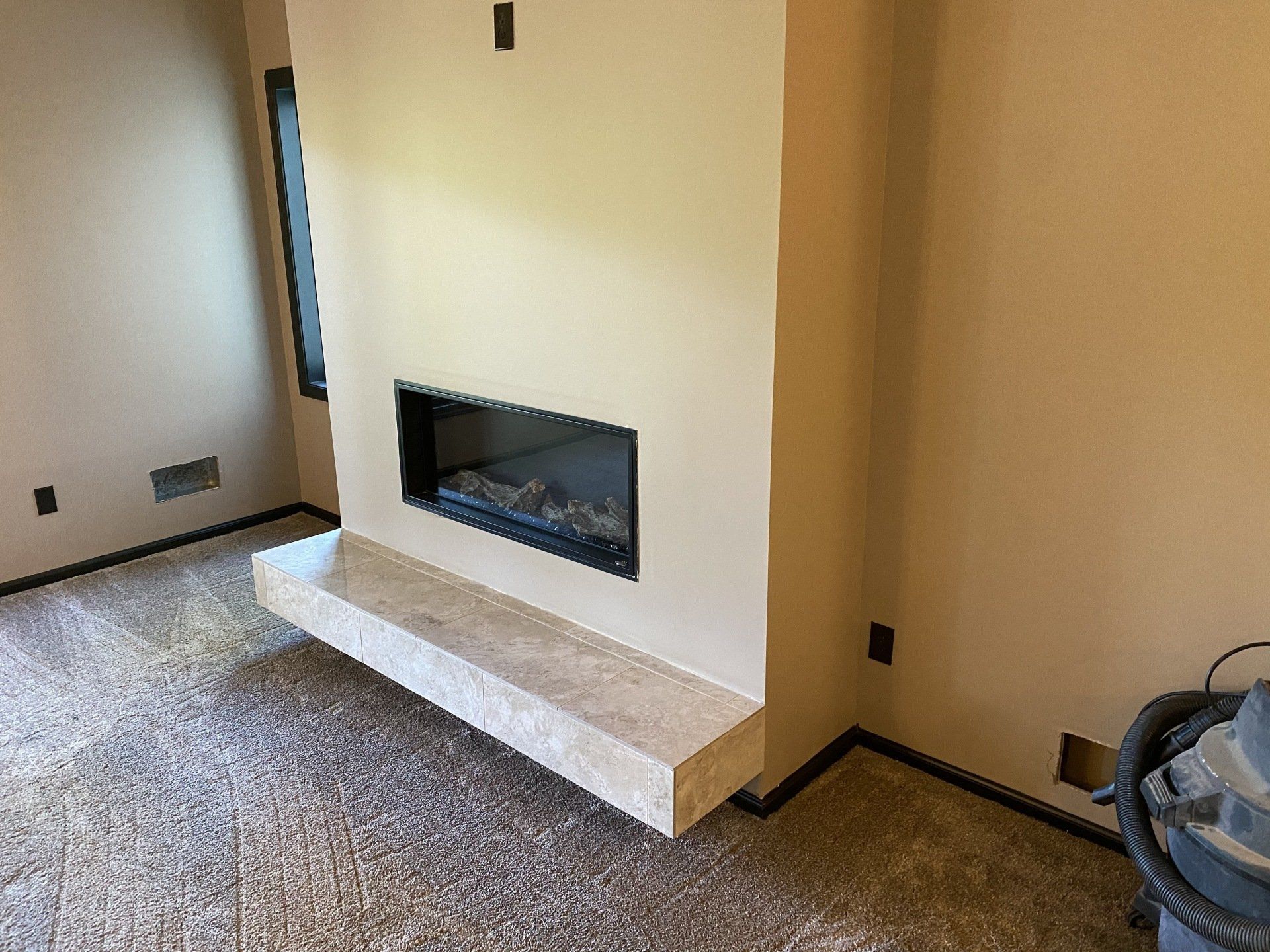 There is a fireplace in the middle of the room.
