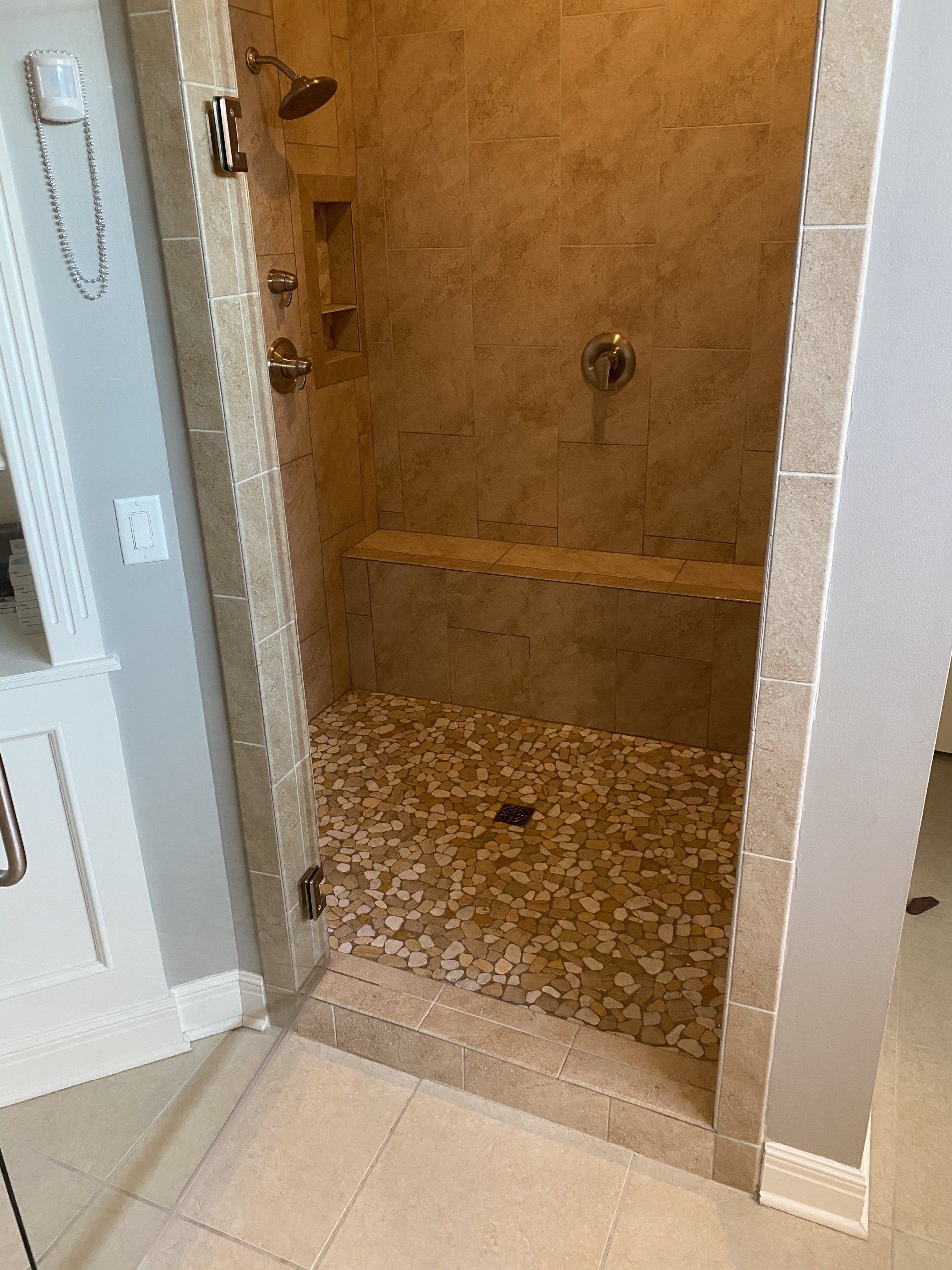 A bathroom with a walk in shower and a bathtub.