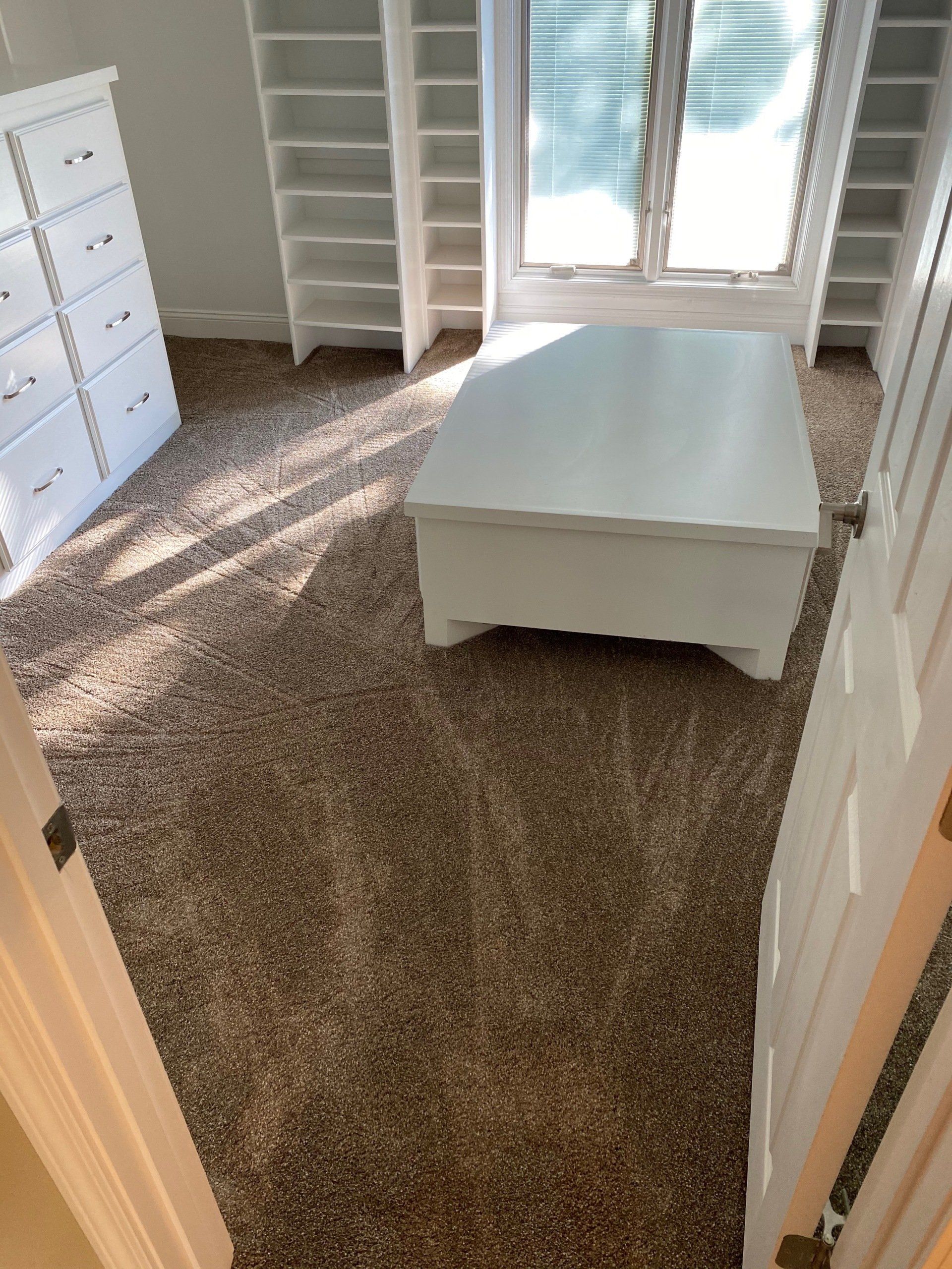 There is a coffee table in the middle of the room.