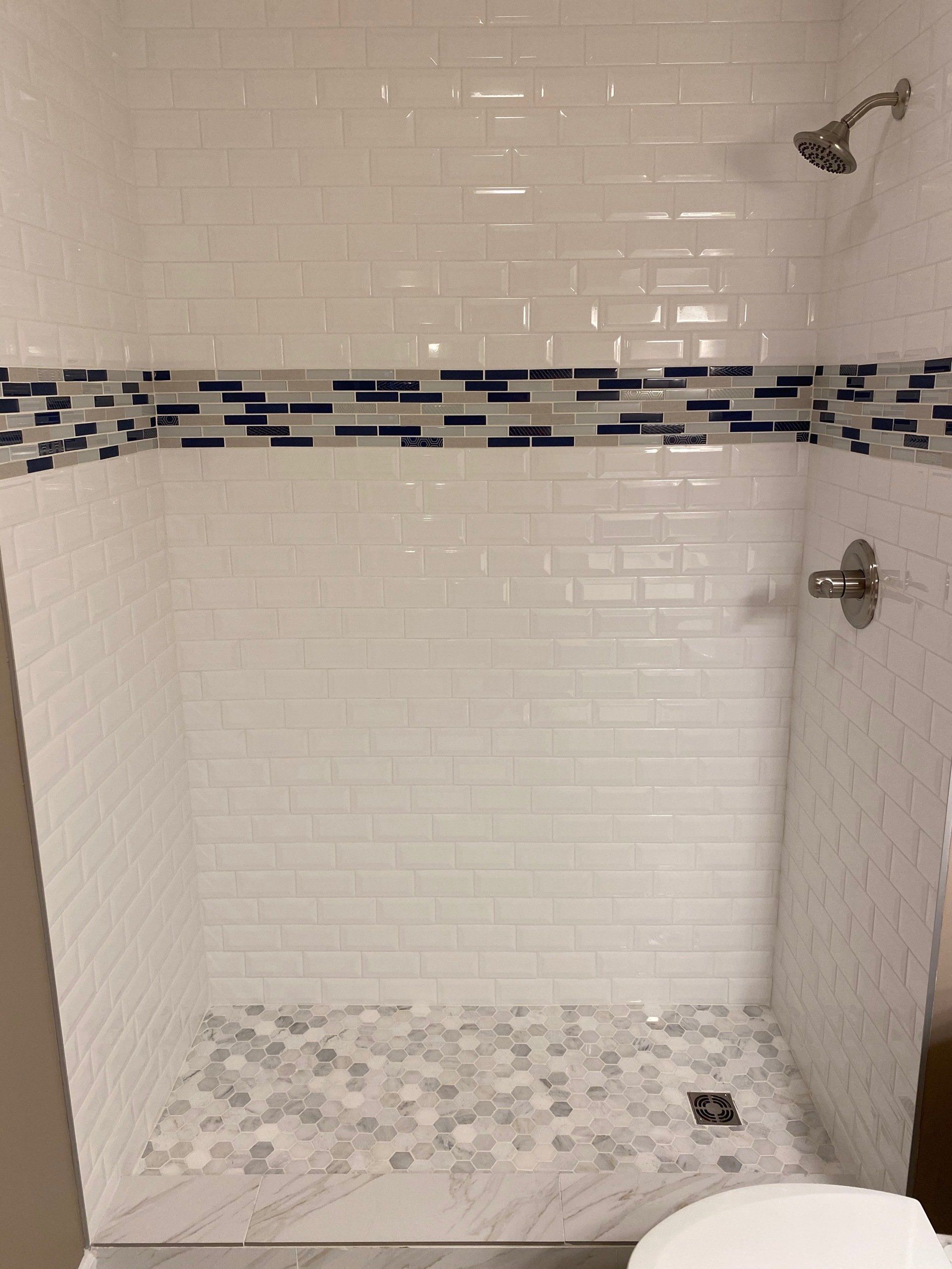 A bathroom with a walk in shower and a toilet.