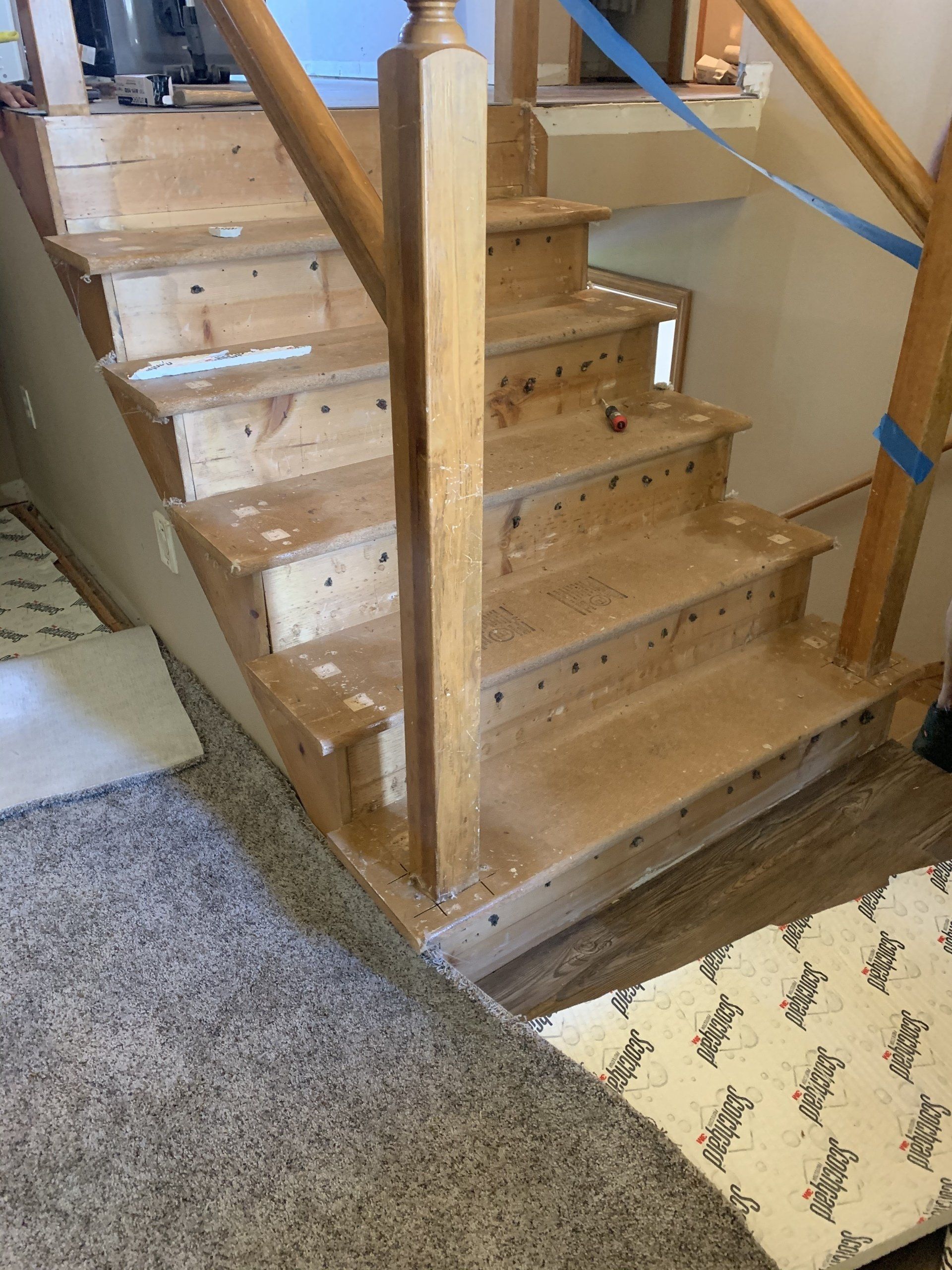 A wooden staircase is being built in a house
