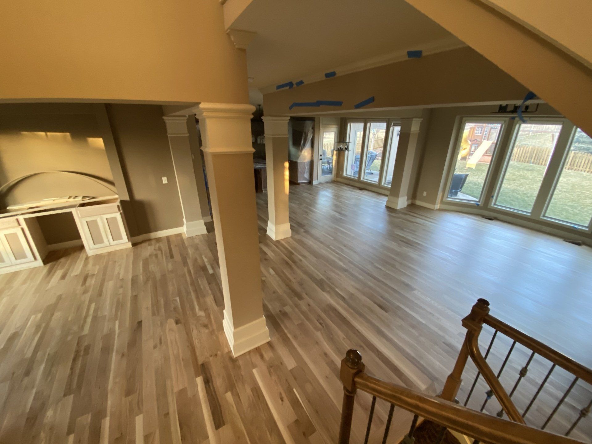 An aerial view of a living room with hardwood floors and stairs.