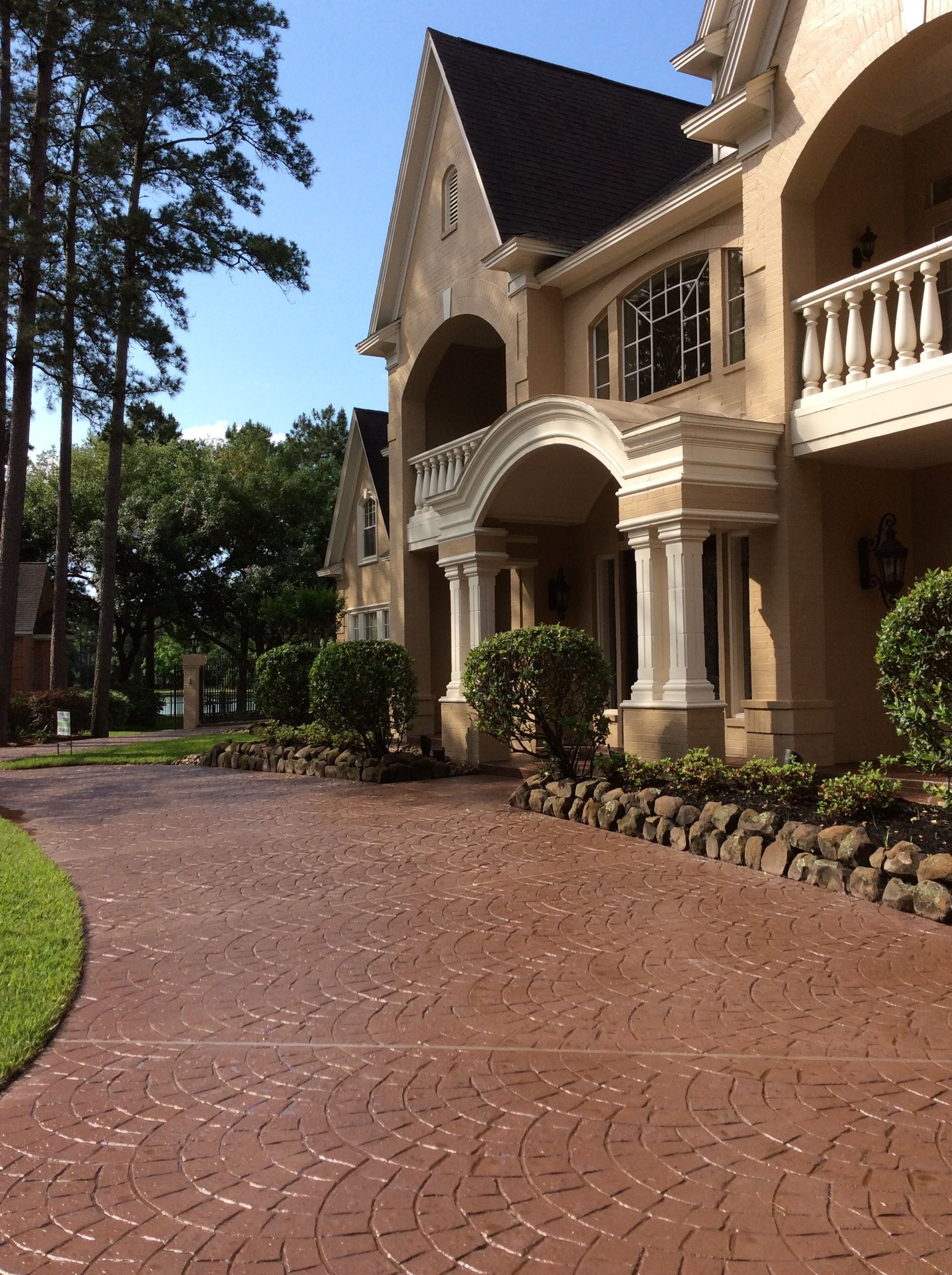A large house with a brick driveway in front of it