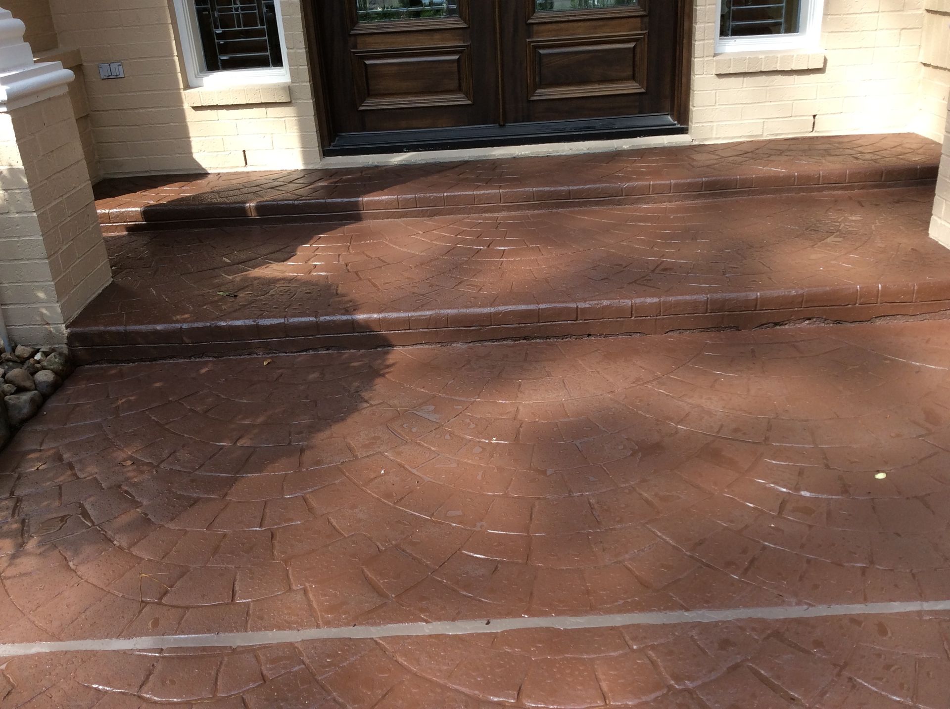 A brick walkway leading to the front door of a house.