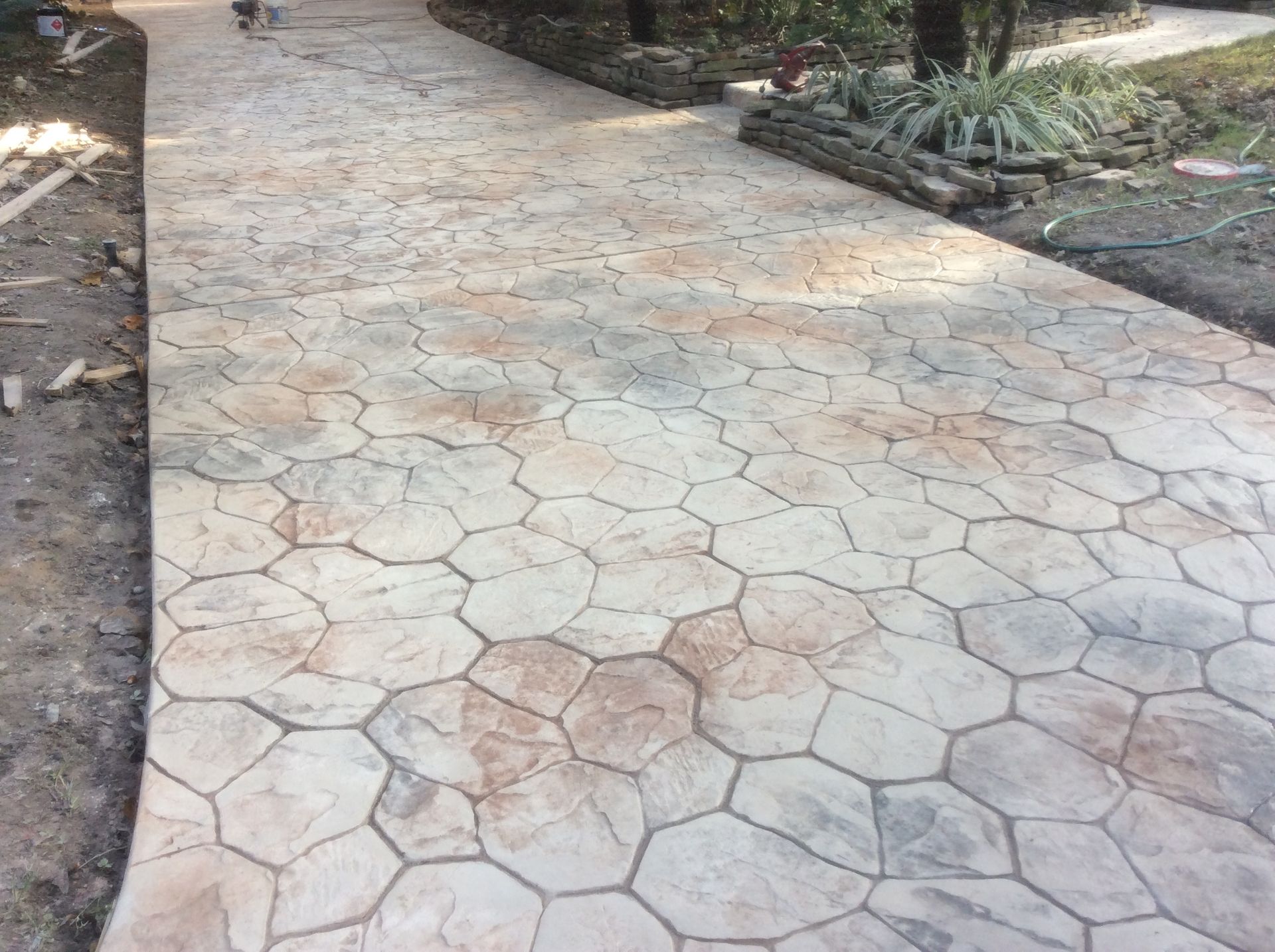 A concrete walkway with a geometric pattern on it