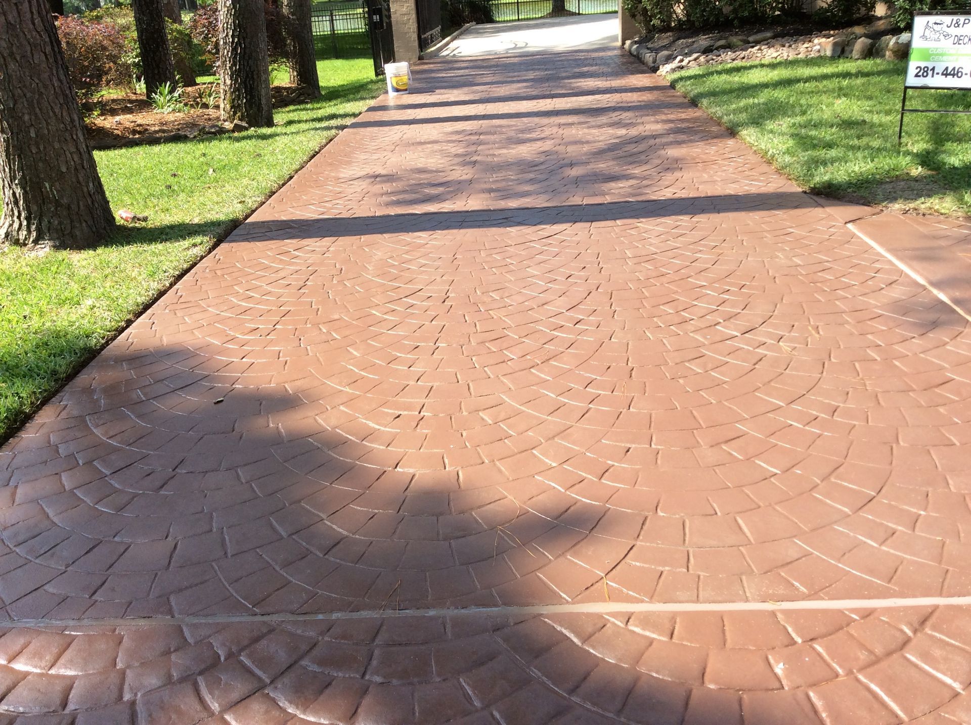 A brick driveway with a sign that says no parking