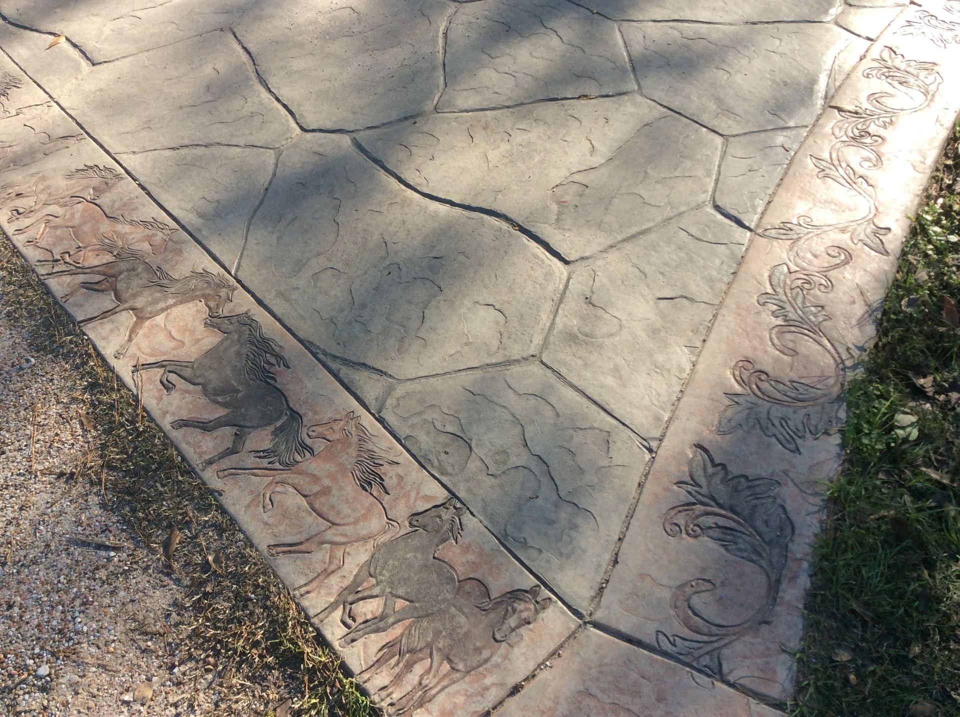 A concrete walkway with a floral design on it