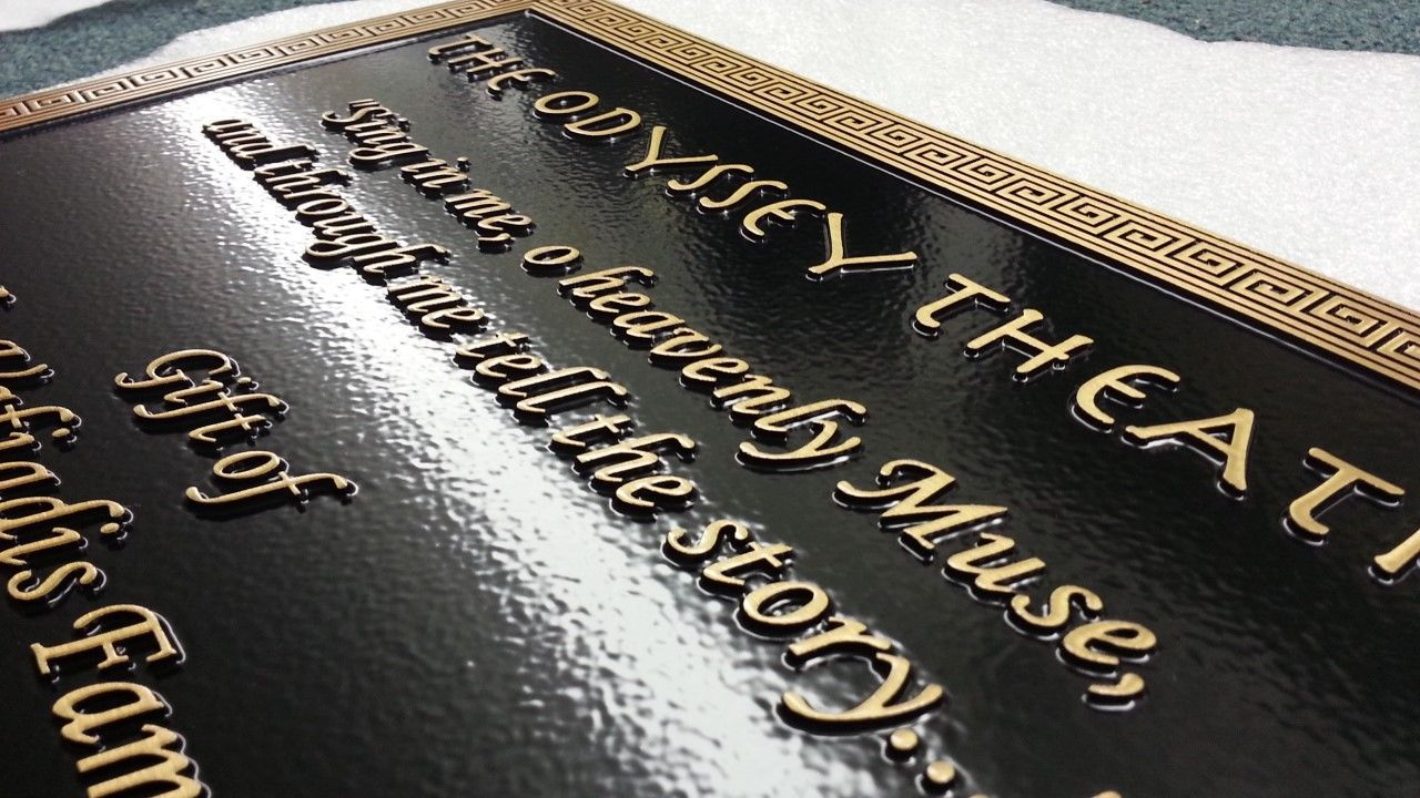 Black plaque with gold text and border