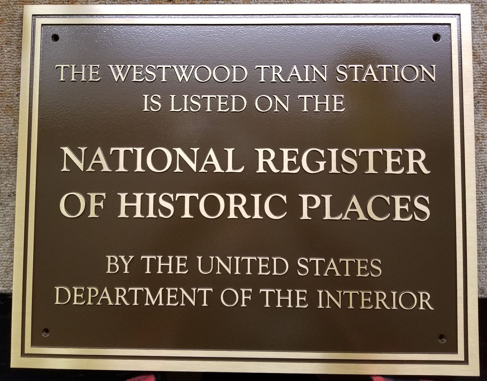 Bronze plaque: The Westwood Train Station listed on the National Register of Historic Places by the Department of the Interior