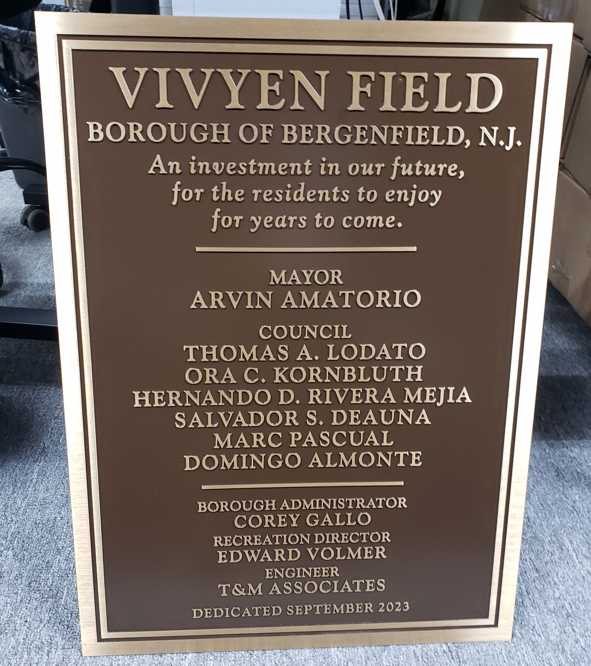 Bronze plaque for Vivyen Field in Bergenfield, NJ, listing names of mayor, council, and associates
