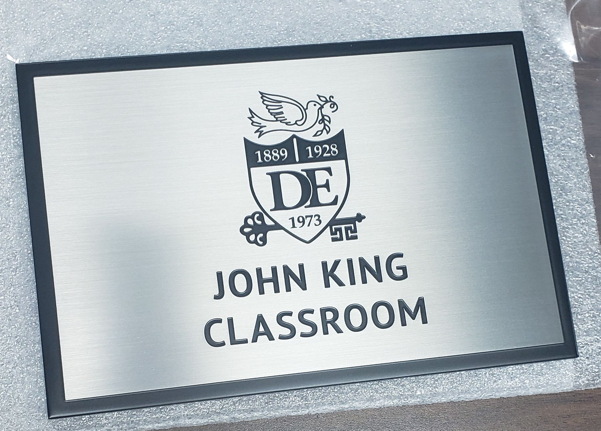 Silver classroom sign with black border