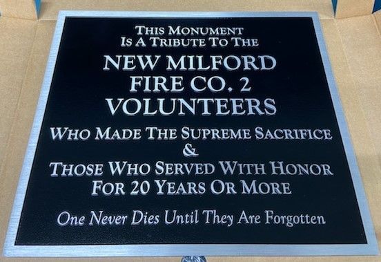 Black plaque with silver lettering