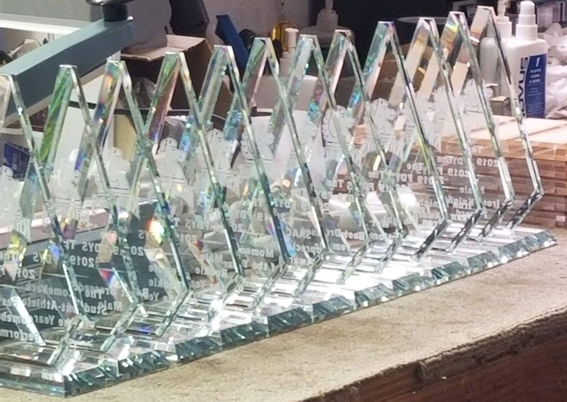 Row of diamond-shaped crystal awards engraved with text