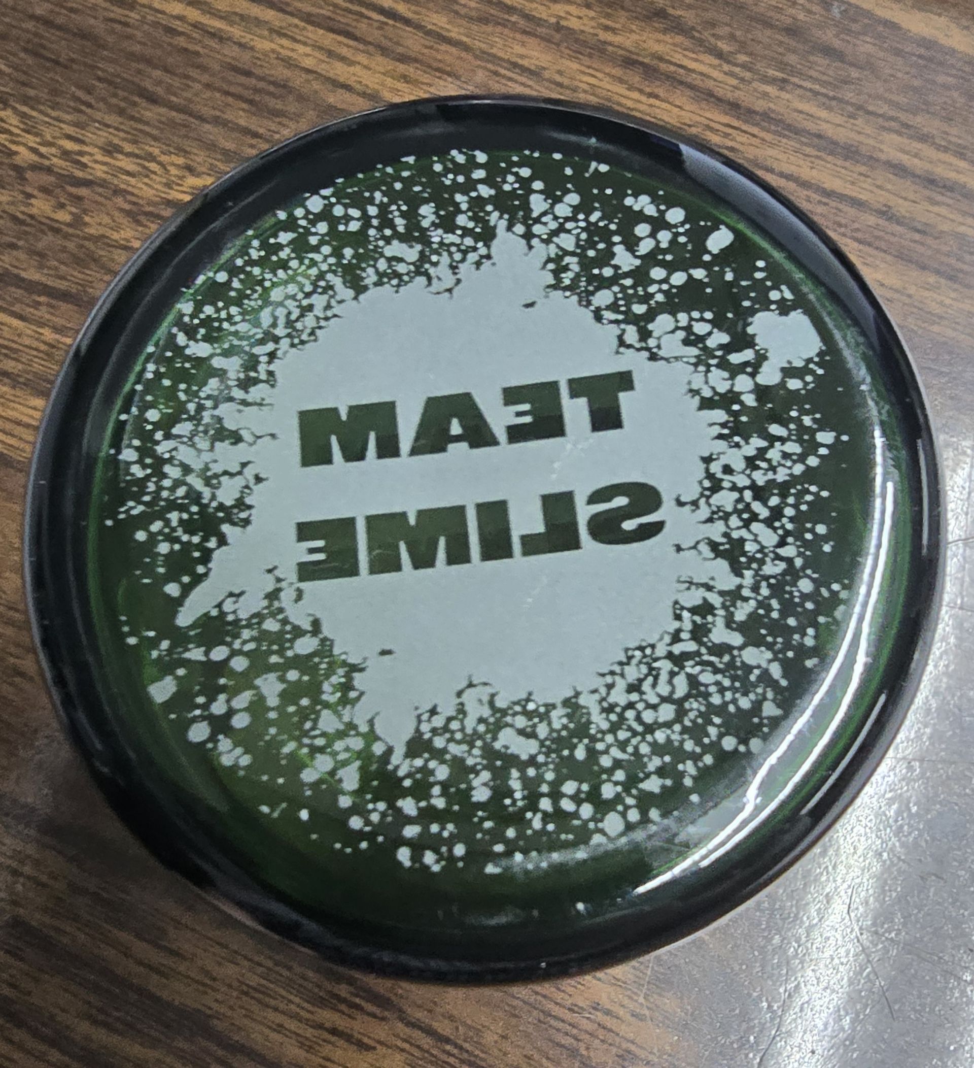Green container lid with white splatter design
