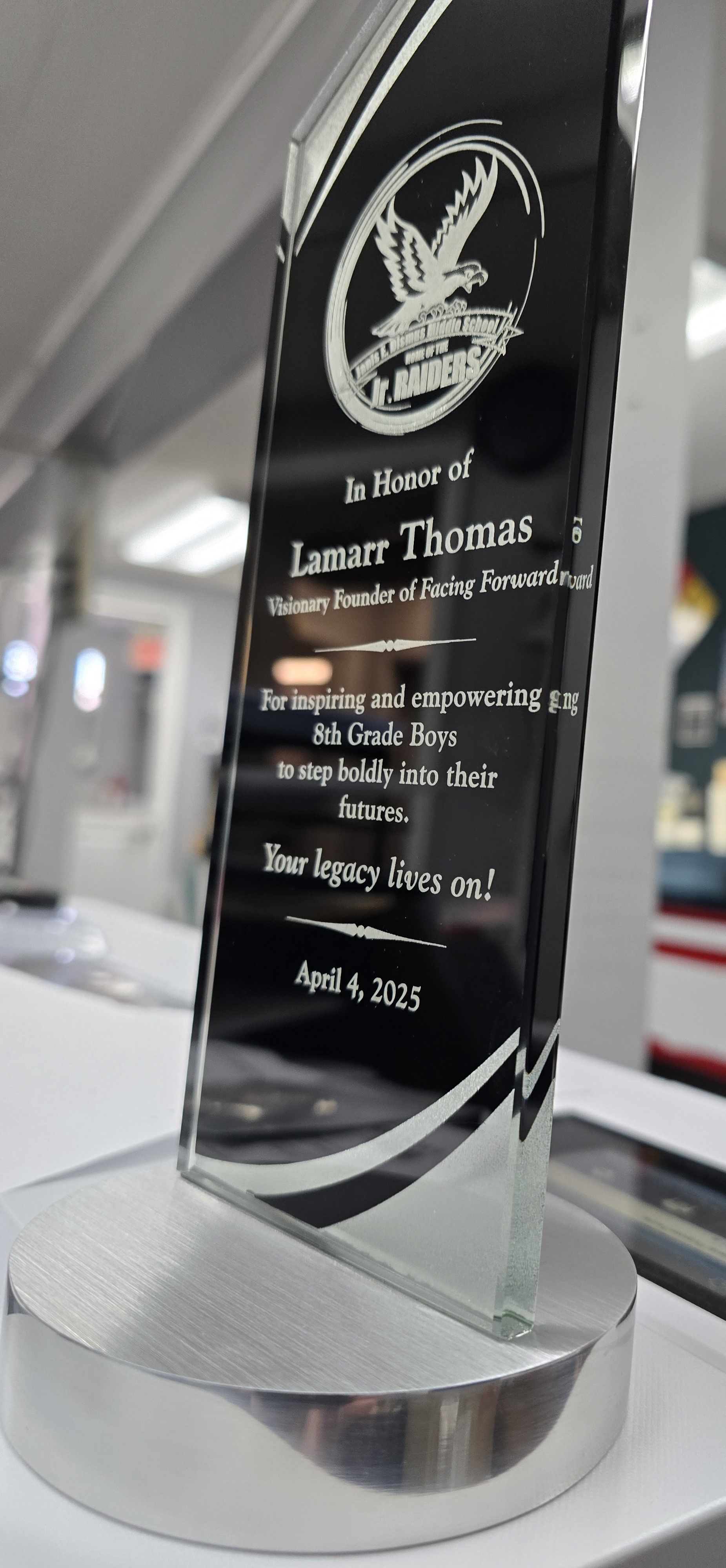 Black and clear engraved trophy on a silver base