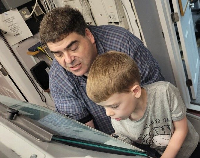 Man and child looking at a device