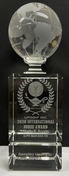 Clear glass award with globe topper