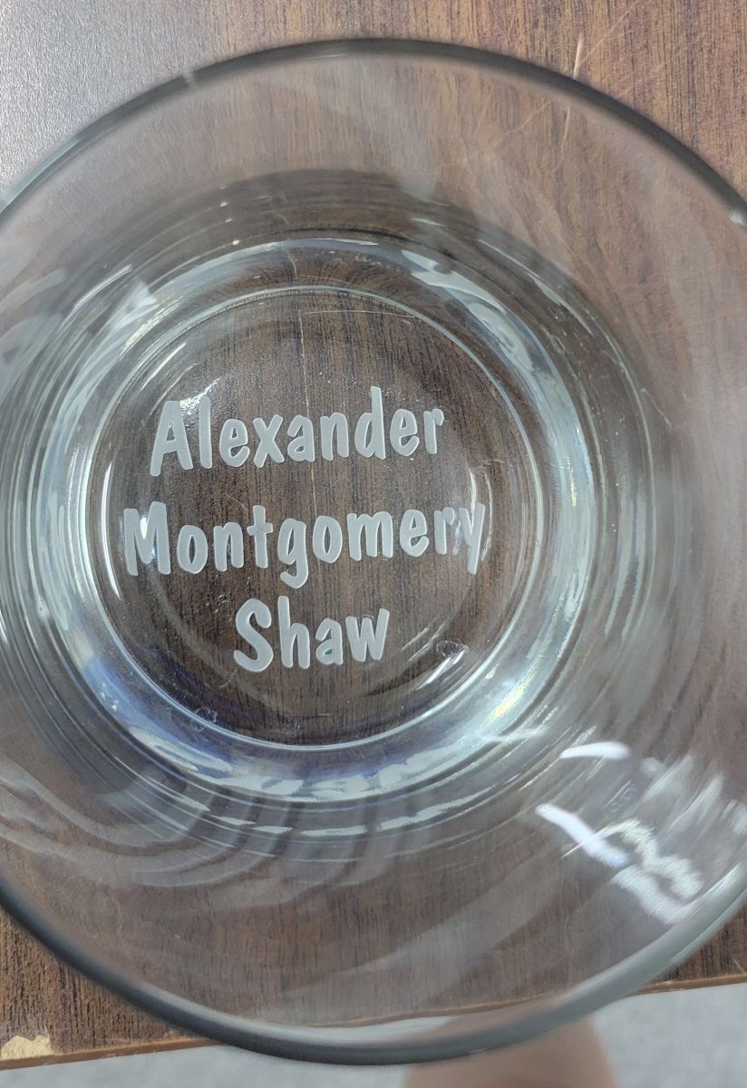 Glass bottom with engraved text