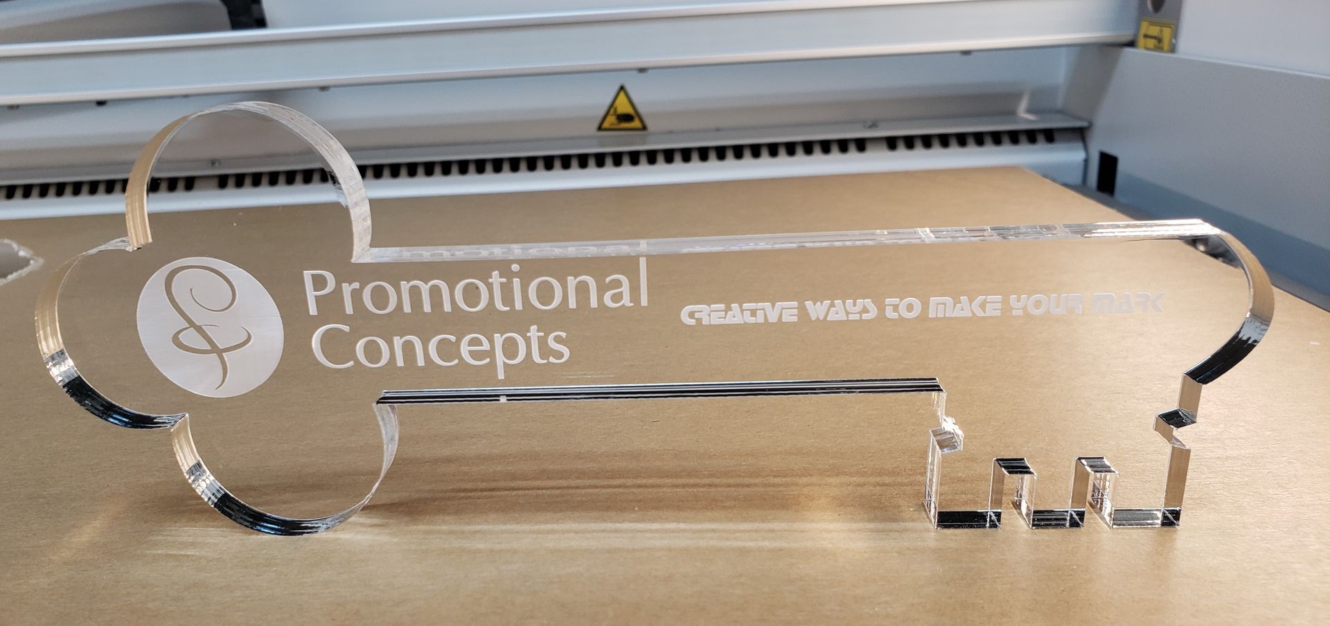 Clear acrylic key-shaped award with engraved text