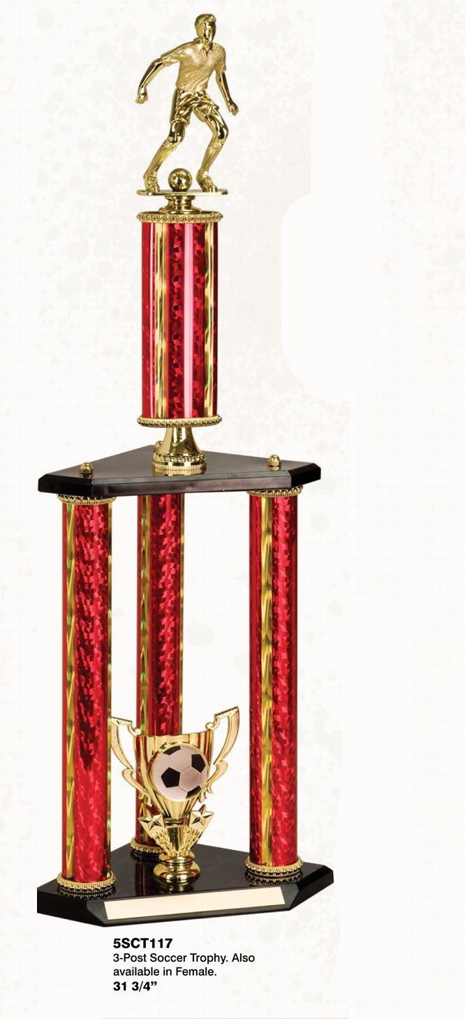 Soccer trophy with red and gold columns, and a golden player figurine on top.