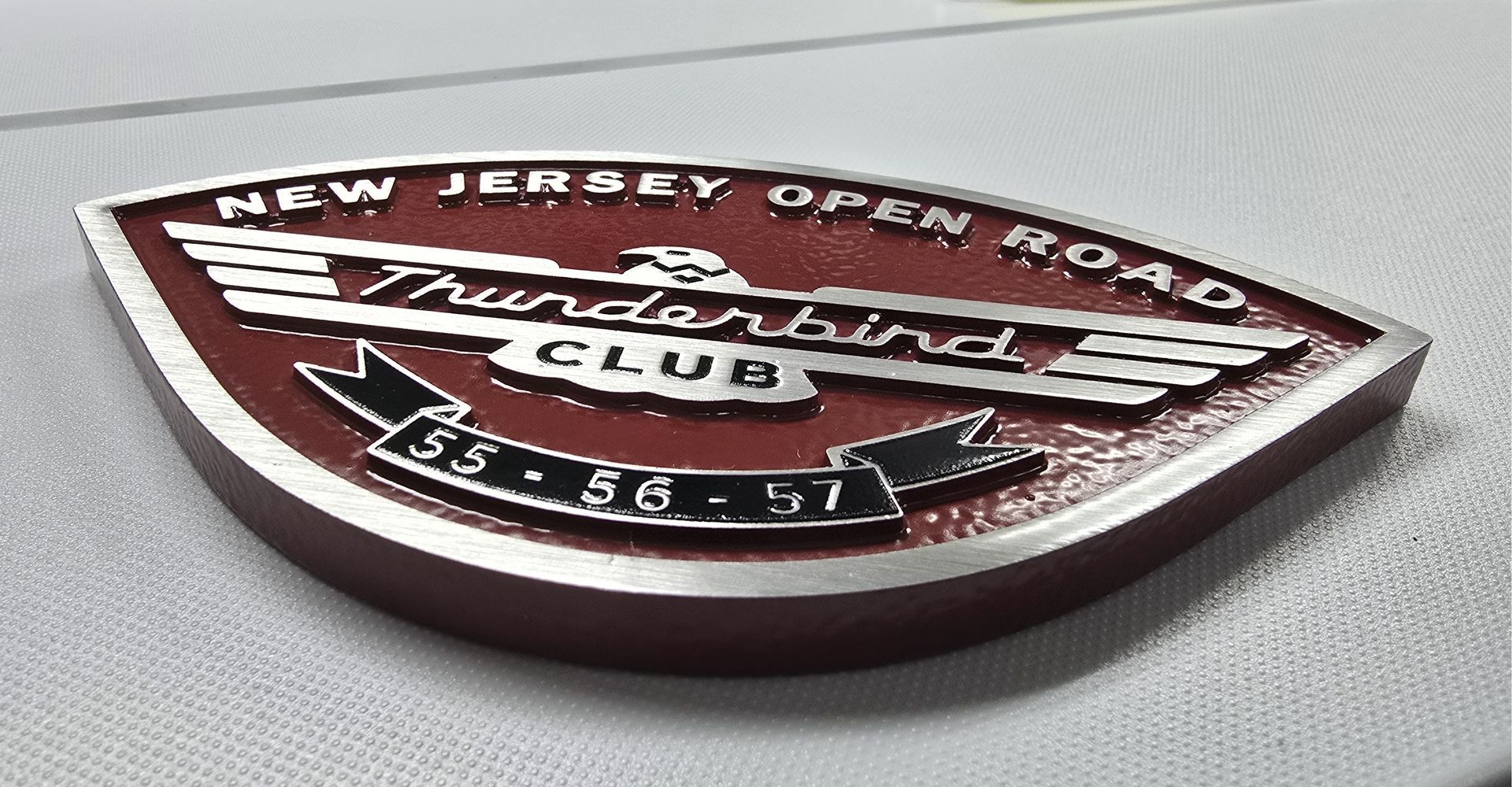Red and silver Thunderbird Club emblem