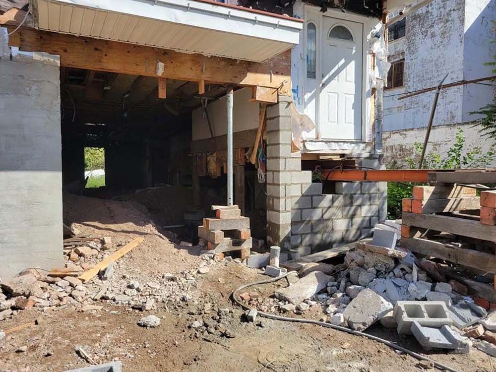 A house is being remodeled with bricks and wood.