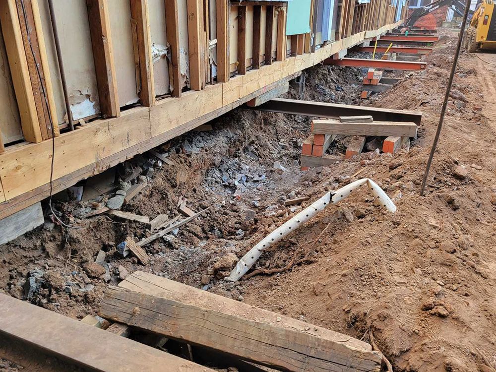 A construction site with a lot of wood and dirt.