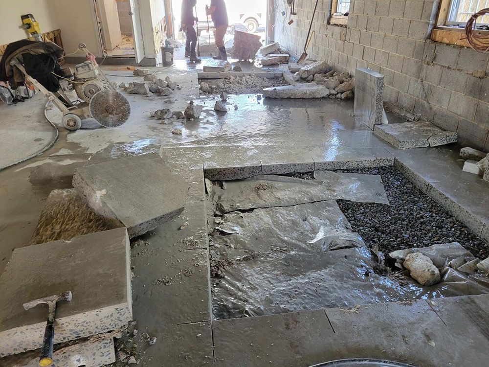 A concrete floor is being cut with a circular saw.