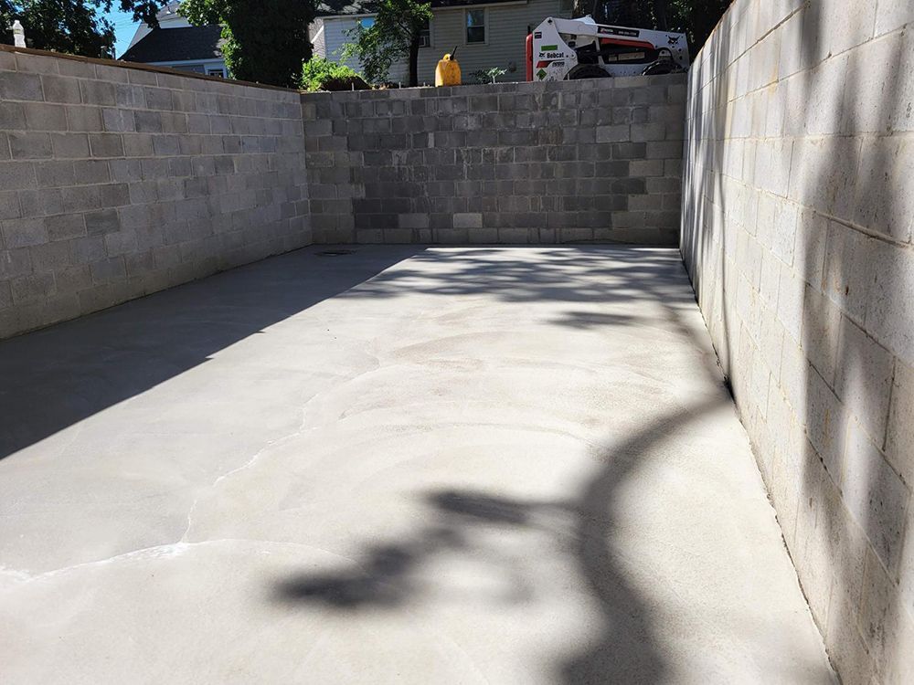 A shadow of a person is cast on a concrete wall