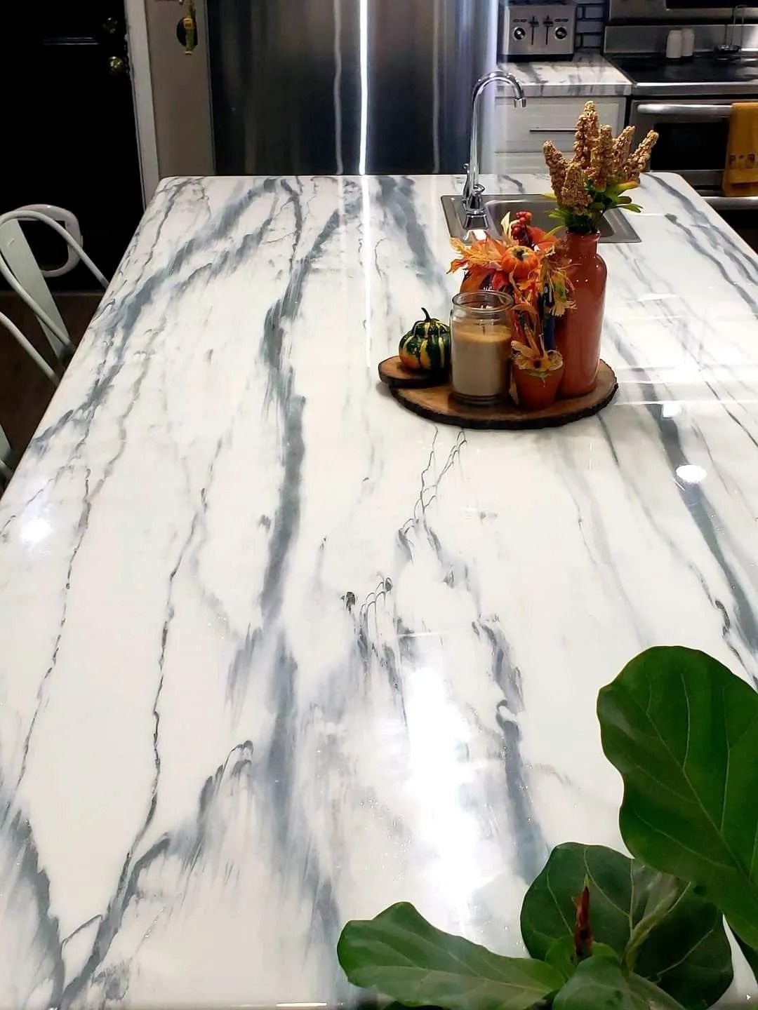 White countertop with gray veining, autumn decor.