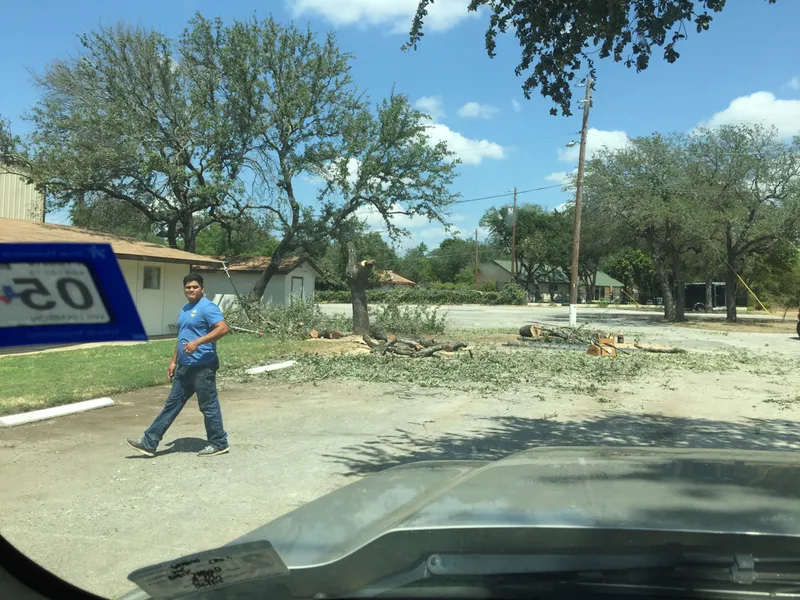 A man walking down a street next to a sign that says $ 20