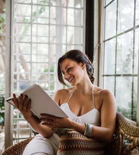 Woman smiling while reading