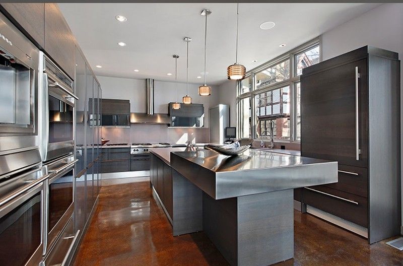 A kitchen with stainless steel appliances and a large island